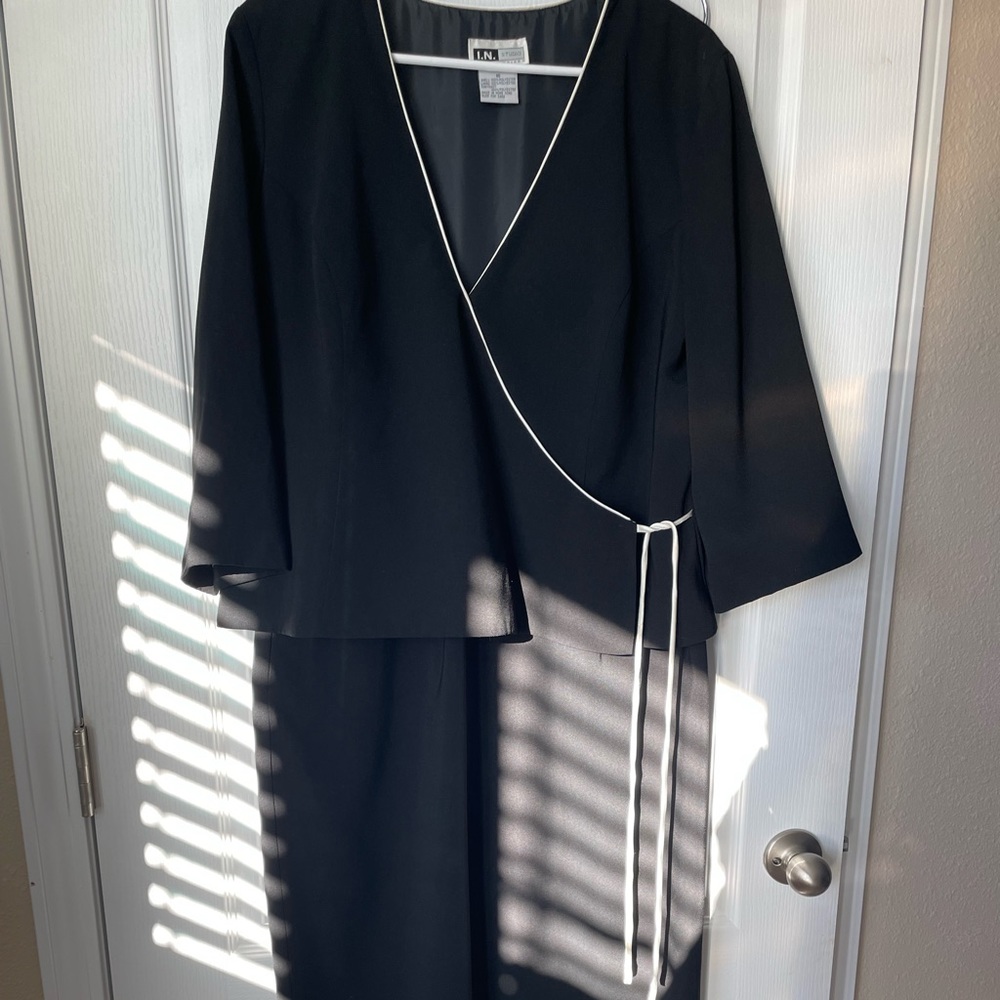 Ladies black dress, wrap style top.
